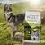 Wolf of Wilderness Soft Green Fields koiranruokapakkaus, teksti: with fresh lamb and sweet potato, for your strong dog, 100% grain-free recipe, 12 kg. Taustalla koira ulkona.