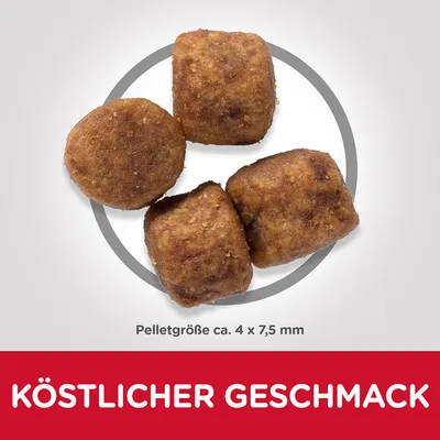 Neljä ruskeaa pellettiä, koko noin 4 × 7,5 mm. Teksti saksaksi: KÖSTLICHER GESCHMACK.