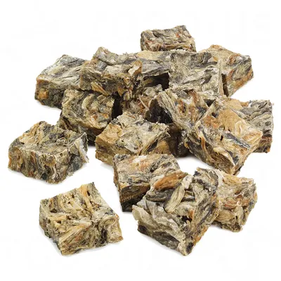 Several dried, square-shaped treats with a marbled texture and natural colours, arranged in a pile on a white background.
