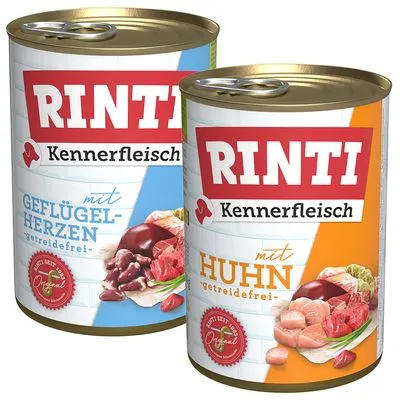 Twee blikken Rinti Kennerfleisch hondenvoer: één met 'Geflügelherzen getreidefrei', één met 'Huhn getreidefrei'. Beide tonen vleesstukken en het rode zegel 'Original'.