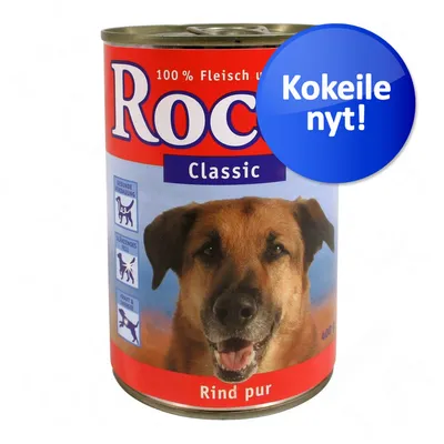 Rocco Classic koiran märkäruoka, Rind pur, 100 % Fleisch und, 400 g. Sininen merkki: Kokeile nyt! Pakkauksessa koiran kuva ja kolme symbolia saksankielisillä teksteillä.