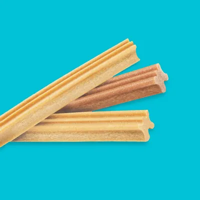Three star-shaped chew sticks in different shades, shown on a blue background to display product shape and texture.