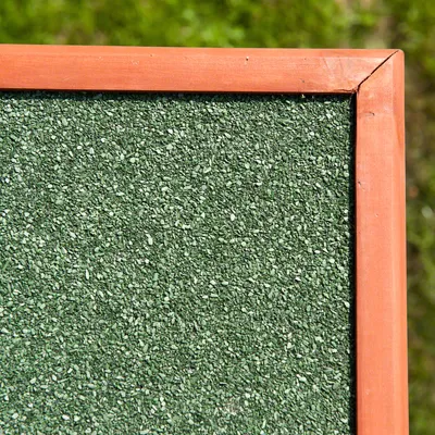 Close-up of a green textured surface with a wooden frame, showing material detail for product construction.