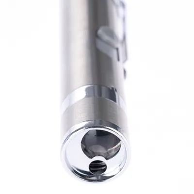 Silver-coloured laser pointer with metal casing and clip, close-up of the lens.