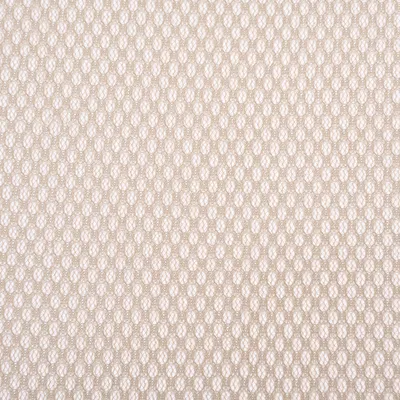 Närbild av ett beige tygmönster i bikakeform.