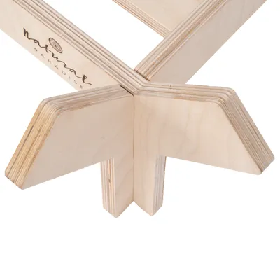 Detailansicht eines Holzgestells aus hellem Schichtholz mit dem Schriftzug 'Natural Paradise'.