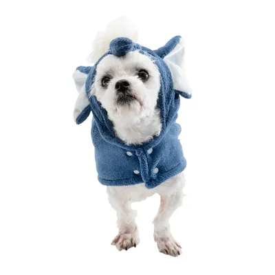 Dog wearing a blue costume with elephant motif, including ears and trunk. Buttons are visible on the front of the costume.