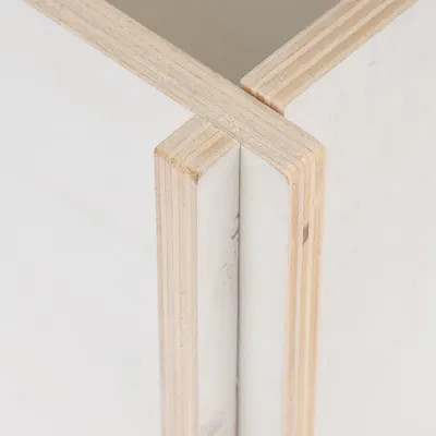 Close-up view of two wooden panels with layered bonding and precise joint.