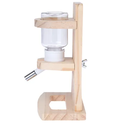 Biberon transparent avec support en bois, bec verseur en métal et plastique, monté verticalement sur socle à vis de fixation visible.