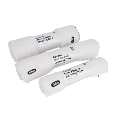 Three cream-coloured, non-electric heating mats in sizes 70x110 cm, 60x75 cm and 45x60 cm. Brand name Tiki visible on label.