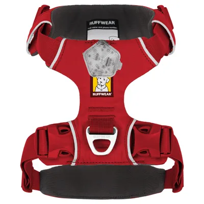 Ruffwear dog harness in red with reflective stripes, sturdy buckles and attachment point. Logo with dog image visible.