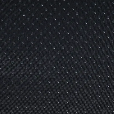 Close-up van een zwart, antislip oppervlak met kleine stippen.