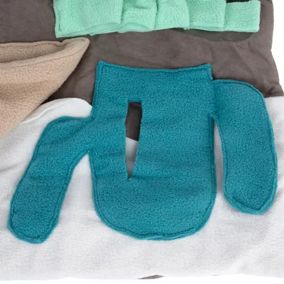 Fleece fabric in various colours, including turquoise, beige, white and mint green. Suitable for DIY projects or pet accessories.
