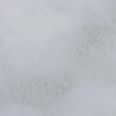 Close-up of white, textured material, possibly padding or filling.