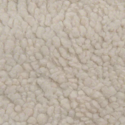 Nahaufnahme von beigem, flauschigem Material mit strukturierter Oberfläche.