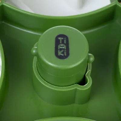 Green product detail with Tiaki logo, possibly part of a pet accessory.