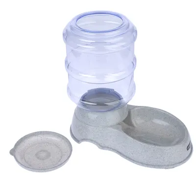 Grey food and water dispenser with transparent container, separate bowl and removable lid. Suitable for automatic feeding of pets.