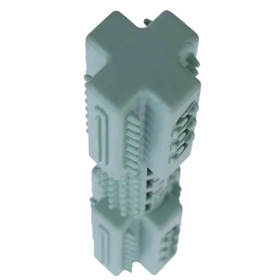 Green cross-shaped toy with textured surfaces and grooves, suitable for interactive play or chewing.