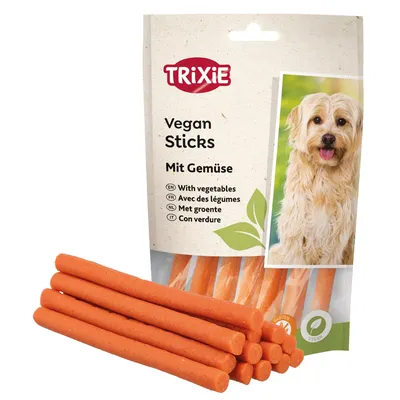 Trixie Vegan Sticks z warzywami. Bezglutenowe i wegańskie. Opakowanie przedstawia pomarańczowe paluszki i motyw liścia.