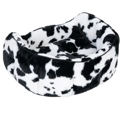 Black and white pet bed with cowhide pattern, soft padding and raised edge.
