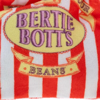 Bertie Bott's Beans. Rayas rojas y blancas con logotipo ovalado amarillo y letras moradas.