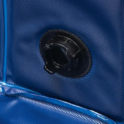 Close-up of a black valve on a blue, textured surface. Detailed view of the material and function of the valve.