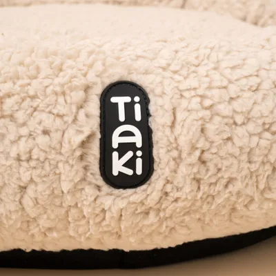 Tiaki Markenlabel auf cremefarbenem, flauschigem Material. Tiaki Markenlabel auf cremefarbenem, flauschigem Material.