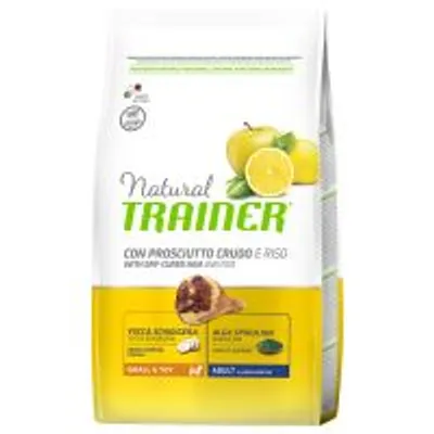 Sacchetto di Natural Trainer con prosciutto crudo e riso, visibili mela, limone, osso, alga spirulina. Testo: Small & Toy, Adult. Adatto per cani adulti di taglia piccola.