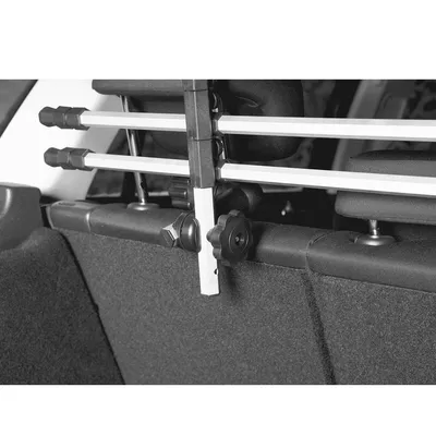 Close-up view of an adjustable car safety gate holder made of metal and plastic, mounted on the back seat of a vehicle.