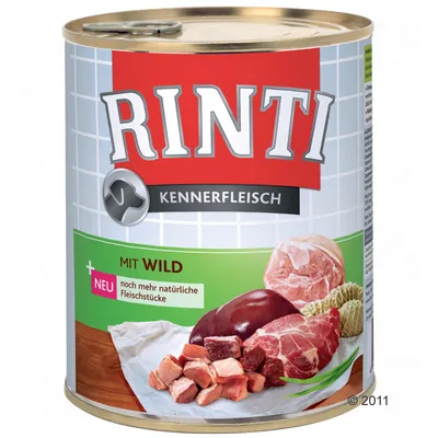 Lata de comida para perros Rinti Kennerfleisch, texto visible: MIT WILD, NEU noch mehr natürliche Fleischstücke. Imagen de trozos de carne en la etiqueta.