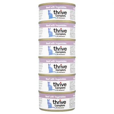 Stack of five tins labelled 'Beef with Vegetables', thrive Complete, 0% Nonsense. Each tin shows a blue animal silhouette and product details.
