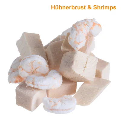 Paloiteltuja vaaleita kuutioita ja pyöreitä paloja, yläreunassa teksti: Hühnerbrust & Shrimps (saksaksi)