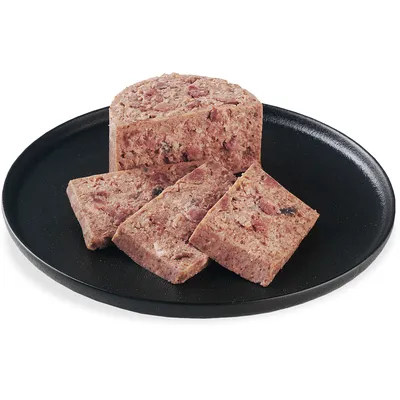 Close-up of sliced wet food on a black plate, showing the texture and composition of the food.