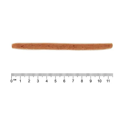 Dolg rjav prigrizek v obliki palice, dolg približno 11 cm, prikazan poleg ravnila za prikaz velikosti.