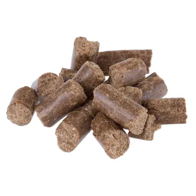 Brown cylindrical pet food treats shown in a pile, displaying their size and texture for product identification.
