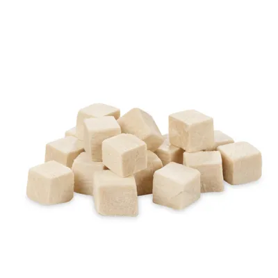 White, cube-shaped snacks made from freeze-dried meat, visibly arranged loosely.