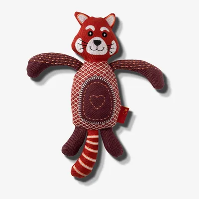 Plush toy shaped like an animal with stitched facial features, patterned body, and a heart design on its belly. The toy has four limbs and a striped tail.