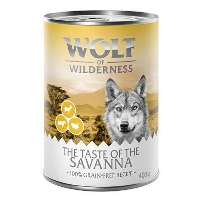 Wolf of Wilderness The Taste of the Savanna, 100% grain-free recipe, 400g. Illustrations de mouton, chèvre et poulet visibles sur l’étiquette.
