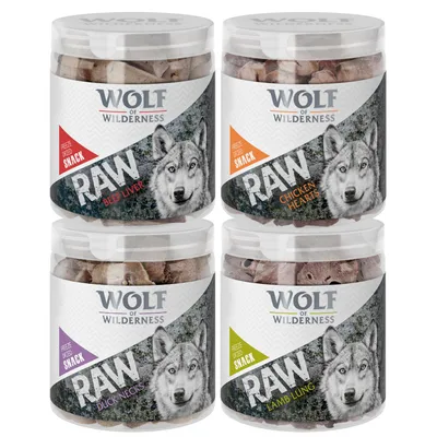 Four tubs of freeze-dried snack labelled RAW: beef liver, chicken hearts, duck necks, and lamb lung. Brand name Wolf of Wilderness visible on each tub.