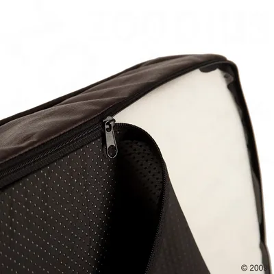 Close-up of a black zip on a padded case with a perforated surface and white interior.