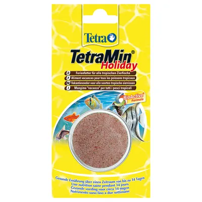 Tetra TetraMin Holiday -loma-ajan ruoka trooppisille akvaariokaloille, BioActive Formula, pakkauksessa näkyy pyöreä ruokapala ja kuvia kaloista. Teksti useilla kielillä.