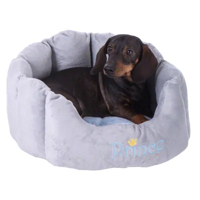 Grey dog bed with embroidered 'Prince' lettering and a small golden crown. Softly padded inside, suitable for small dogs. Grey dog bed with embroidered 'Prince' lettering and a small golden crown. Softly padded inside, suitable for small dogs.