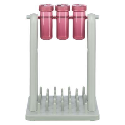 Interactief hondenspeelgoed van kunststof met drie roze draaibare buizen op een wit frame en pinnen op de basis. Geschikt voor het verstoppen van snacks of brokjes.