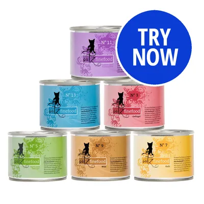 Selection of six tins labelled catz finefood with different numbers and colours, plus a blue circle with white text reading TRY NOW.