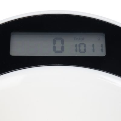 Digitální displej kuchyňské váhy s měřením '0' a '1011 g Total'.