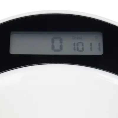 Дигитален дисплей на кухненска везна с измерване „0“ и „1011 g Total“.