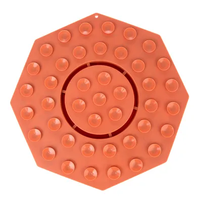 Covoraș hexagonal din silicon portocaliu cu proeminențe ridicate, potrivit pentru hrănire lentă sau activitate. Adâncitură centrală vizibilă.