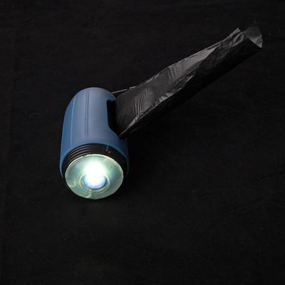 Blue torch holder with integrated dispenser function for black waste bags, visible bright light.