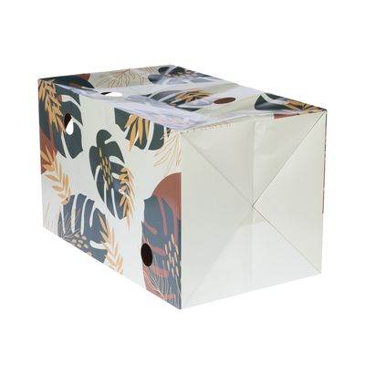 Foldable box with tropical leaf pattern in green, brown and yellow. Two round handle holes on the sides.