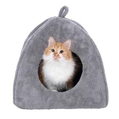 Grey, soft cat house with round entrance. A red and white cat is sitting inside and looking out. Grey, soft cat house with round entrance. A red and white cat is sitting inside and looking out.
